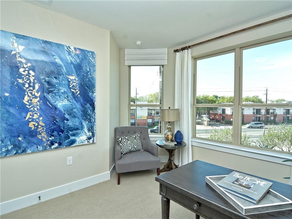 12504 Red Sparrow Street, Unit 1 Austin, TX 78729 - Photo 9 of 22 a living room with a couch and a large window