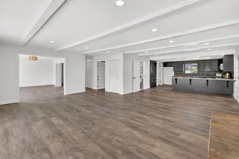 a kitchen with kitchen island granite countertop a sink appliances and cabinets