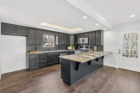 a kitchen with a refrigerator and windows