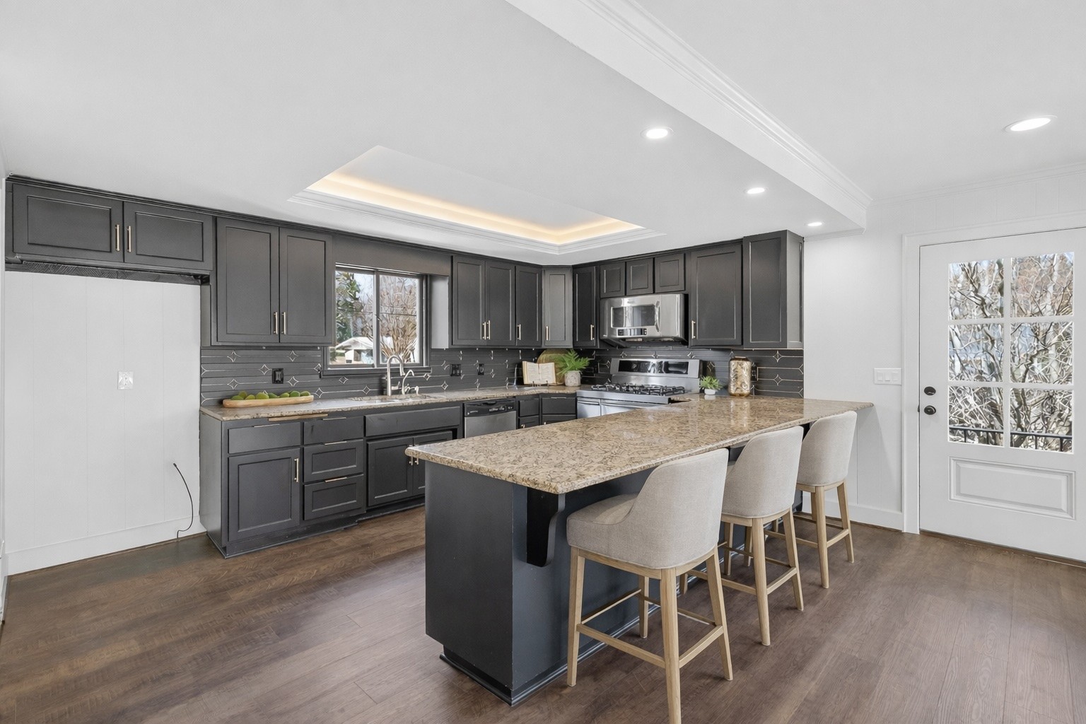 91 Country Club Terrace Winchester, TN 37398 - Photo 19 of 74 a kitchen with kitchen island granite countertop wooden floors white appliances and cabinets