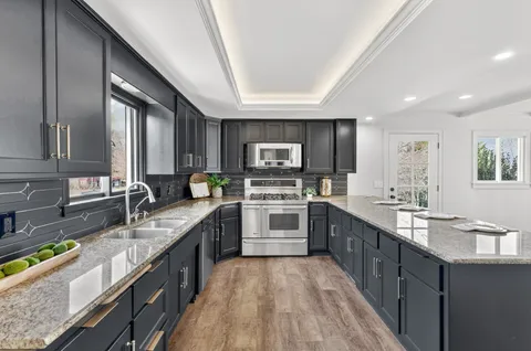 a bedroom with a large bed and a chandelier