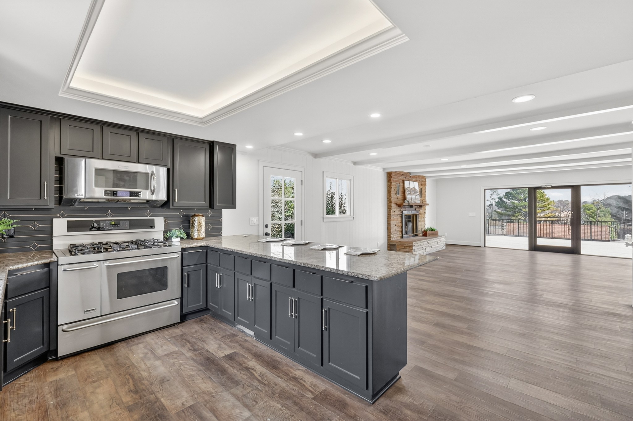 91 Country Club Terrace Winchester, TN 37398 - Photo 21 of 74 a kitchen with stainless steel appliances granite countertop a stove top oven a sink dishwasher a microwave oven and a refrigerator with wooden floor