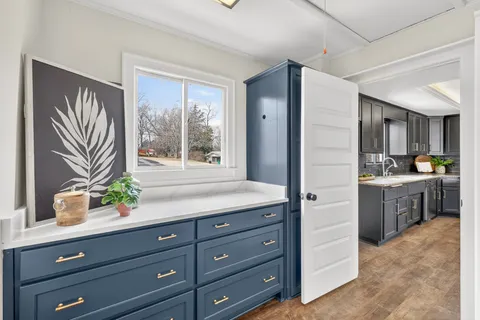 a bathroom with a sink double vanity granite tub shower and a mirror