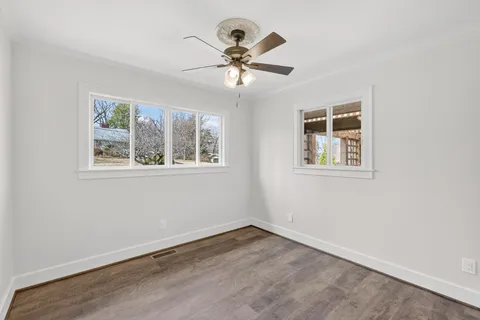 a view of balcony with wooden floor and seating space