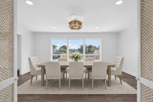 a kitchen with stainless steel appliances granite countertop a stove top oven a sink dishwasher a microwave oven and a refrigerator with wooden floor