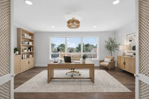 a kitchen with stainless steel appliances granite countertop a stove top oven a sink dishwasher a microwave oven and a refrigerator with wooden floor