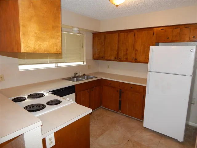 a kitchen with a refrigerator and a sink