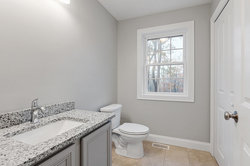 150 French Road, Unit LOT 4 Templeton, MA 01468 - Photo 16 of 28 a bathroom with a granite countertop sink a toilet and a window