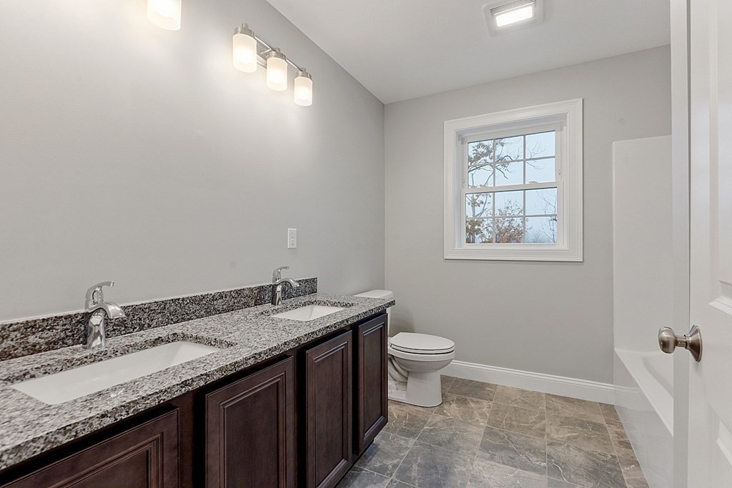 150 French Road, Unit LOT 4 Templeton, MA 01468 - Photo 19 of 28 a bathroom with a granite countertop sink a toilet and a window
