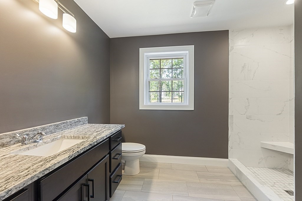 150 French Road, Unit LOT 4 Templeton, MA 01468 - Photo 24 of 28 a bathroom with a granite countertop sink a toilet and a window