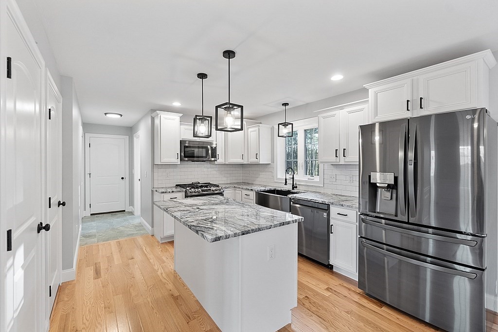 150 French Road, Unit LOT 4 Templeton, MA 01468 - Photo 8 of 28 a kitchen with stainless steel appliances granite countertop a refrigerator a sink dishwasher a stove and white cabinets with wooden floor