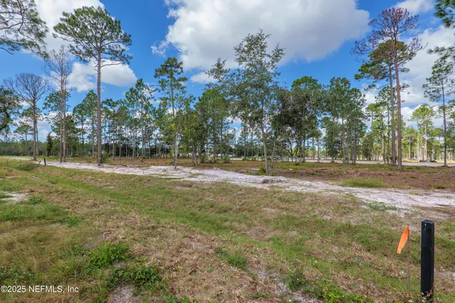 a living room with furniture a flat screen tv and a floor to ceiling window