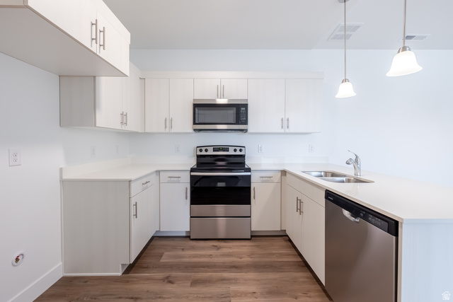 693 West 4500th South, Unit O301 Mapleton, UT 84664 - Photo 11 of 16 Kitchen featuring stainless steel appliances, a peninsula, dark wood-style floors, and pendant lighting
