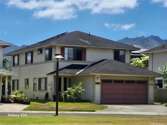 a front view of a house with a garden