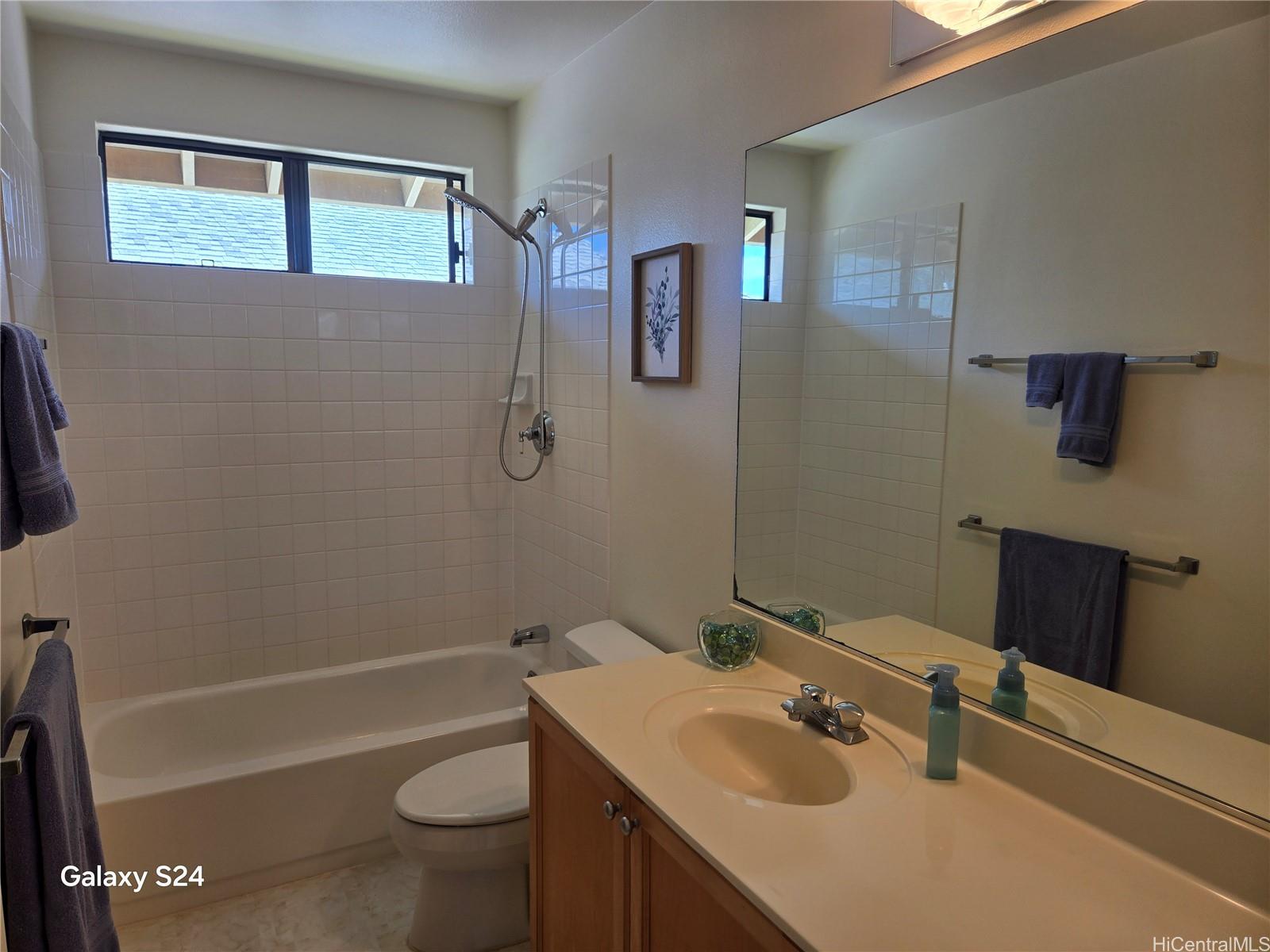 94-1008 Makakoa Loop Waipahu, HI 96797 - Photo 18 of 24 a bathroom with a sink a toilet and shower