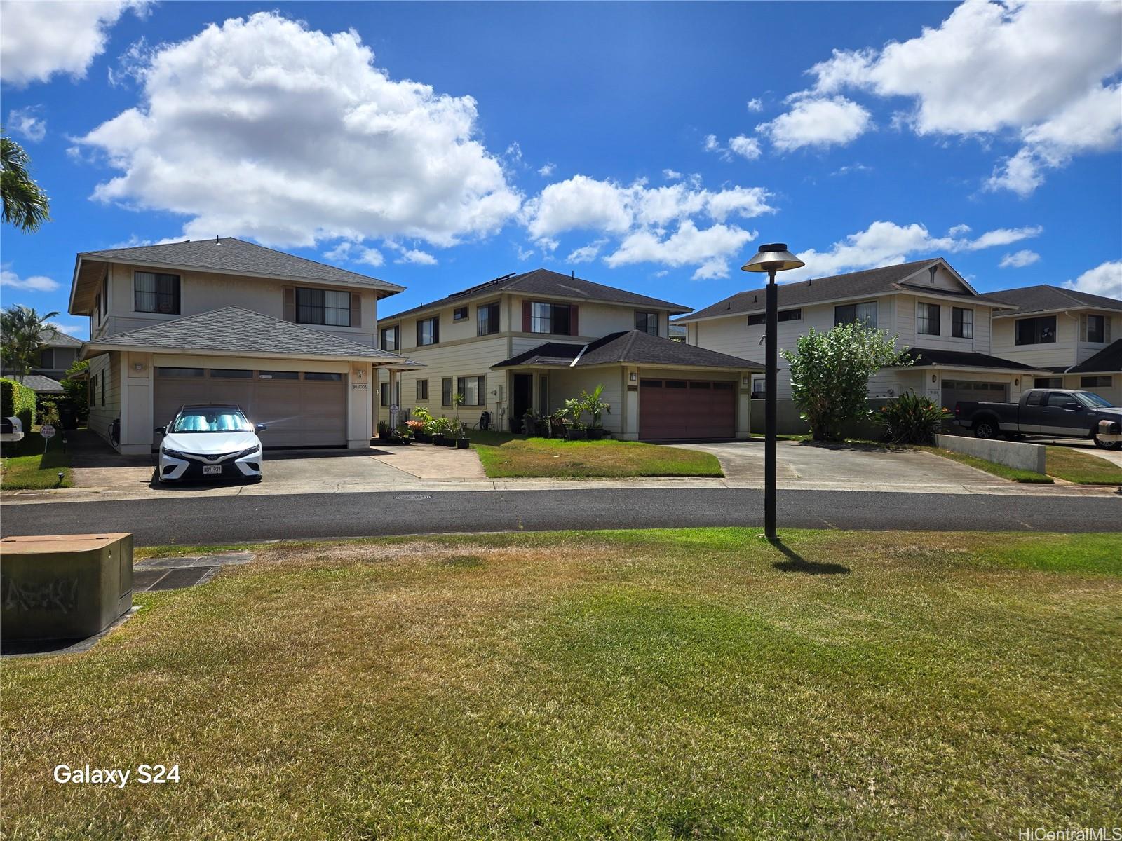 94-1008 Makakoa Loop Waipahu, HI 96797 - Photo 2 of 24 a swimming pool view with a seating space and a garden view