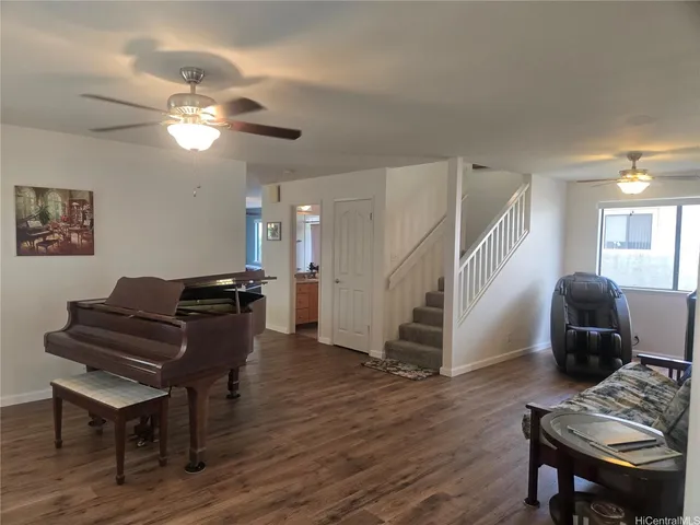 a living room with furniture and a piano