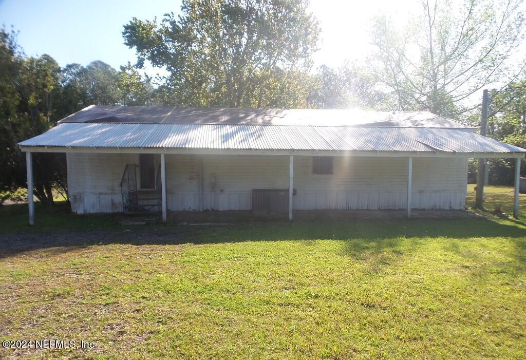 1831 Forbes Road, Unit 1 St. Augustine, FL 32092 - Photo 2 of 20 a view of a house with a yard and a patio