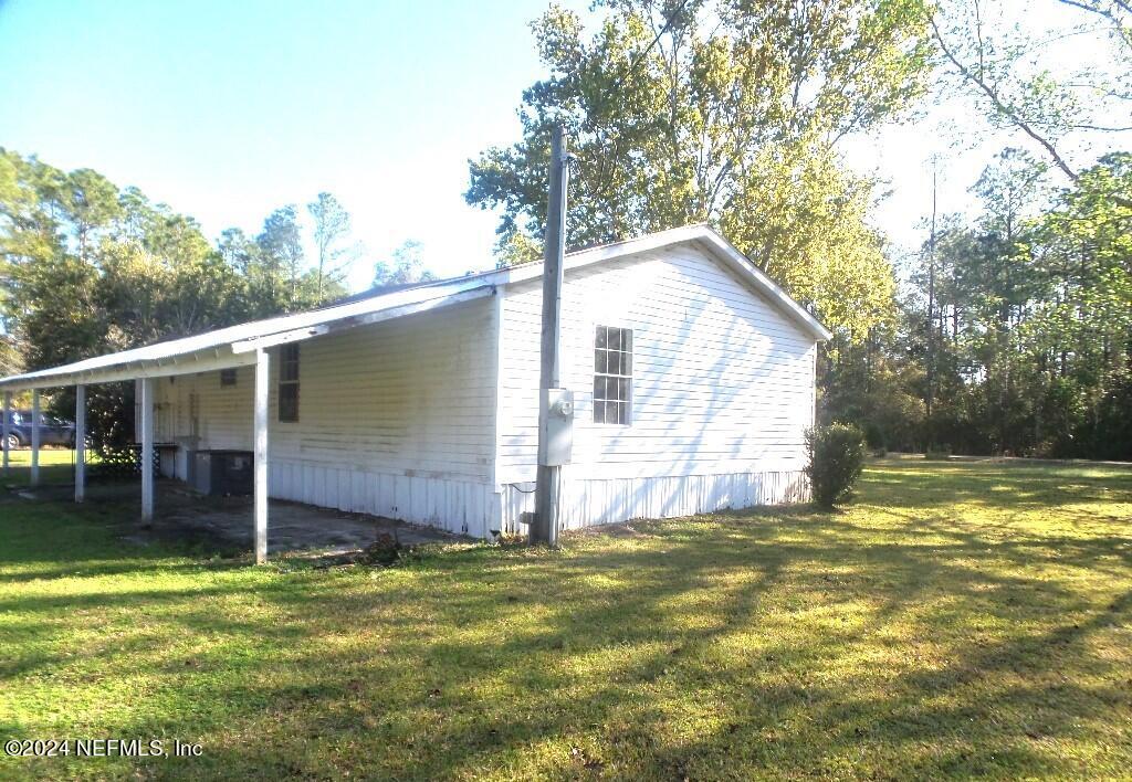 1831 Forbes Road, Unit 1 St. Augustine, FL 32092 - Photo 3 of 20 a view of a house with backyard and sitting area