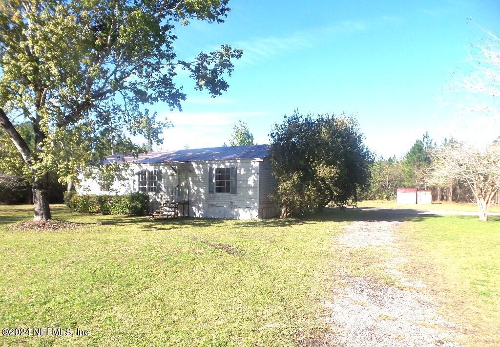 1831 Forbes Road, Unit 1 St. Augustine, FL 32092 - Photo 4 of 20 a view of a house with a yard and a large tree
