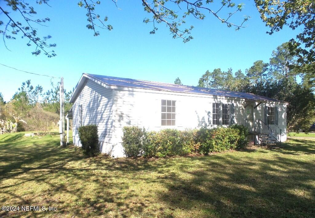 1831 Forbes Road, Unit 1 St. Augustine, FL 32092 - Photo 5 of 20 a view of a house with backyard and garden
