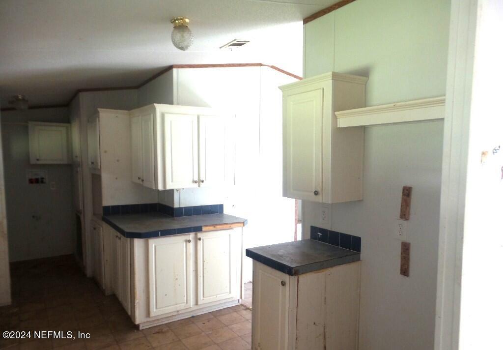 1831 Forbes Road, Unit 1 St. Augustine, FL 32092 - Photo 6 of 20 a bathroom with a sink a mirror and a shower