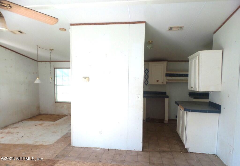 1831 Forbes Road, Unit 1 St. Augustine, FL 32092 - Photo 7 of 20 a kitchen with a refrigerator and a sink