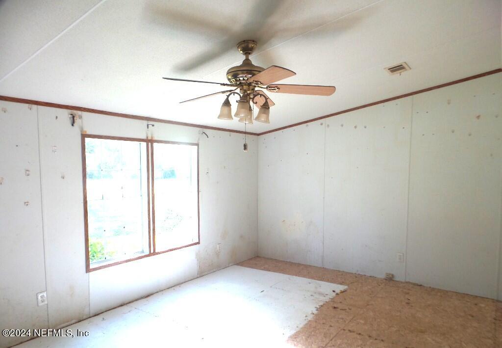 1831 Forbes Road, Unit 1 St. Augustine, FL 32092 - Photo 10 of 20 a view of a room with a window and a chandelier fan
