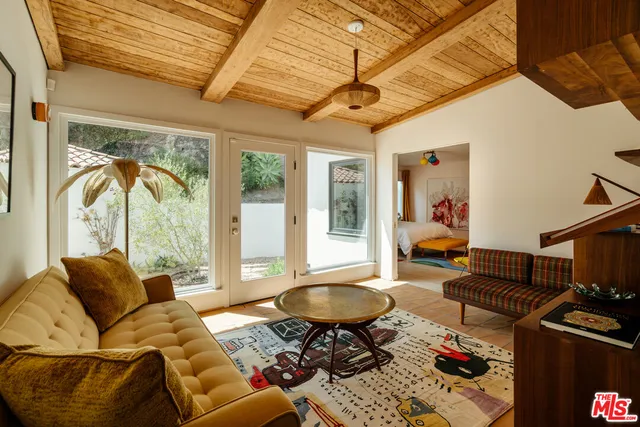 a living room with a couch and wooden floor