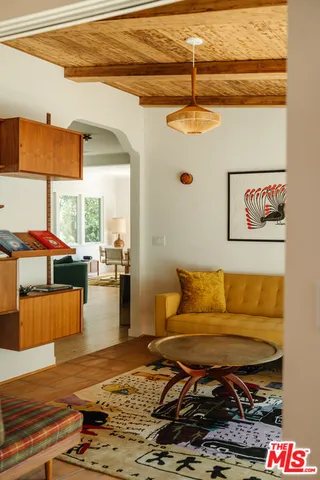 a bedroom with a bed and a painting on the wall