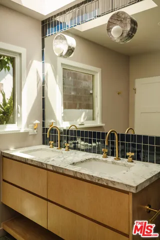 a bedroom with two beds and a window