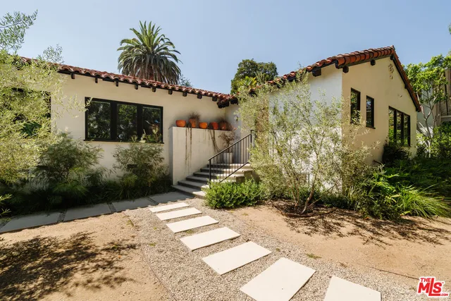 a front view of a house with garden