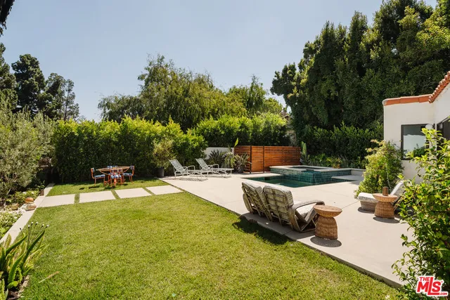 a view of a backyard with plants and a patio