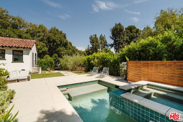 a view of swimming pool with a yard and seating area