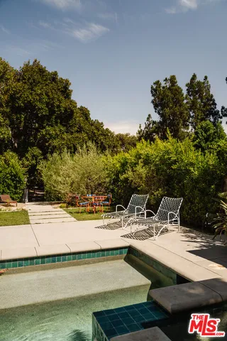 a view of a chair and tables in the patio