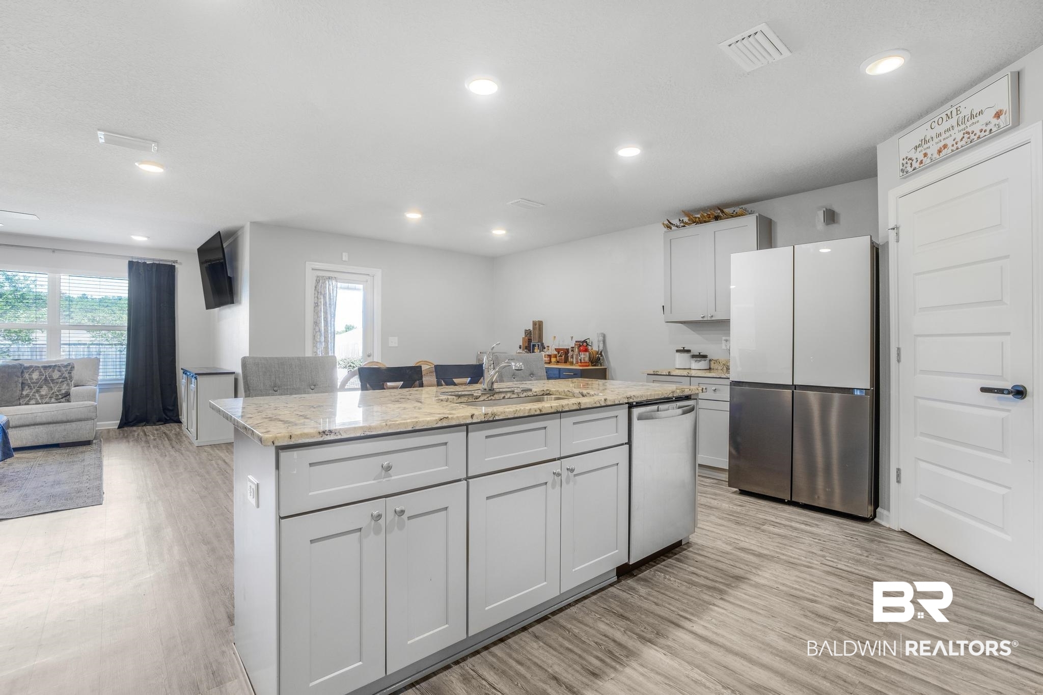 10738 Ridgeview Drive Mobile, AL 36608 - Photo 6 of 48 Kitchen featuring appliances with stainless steel finishes, a center island, light wood-style floors, light stone counters, and recessed lighting