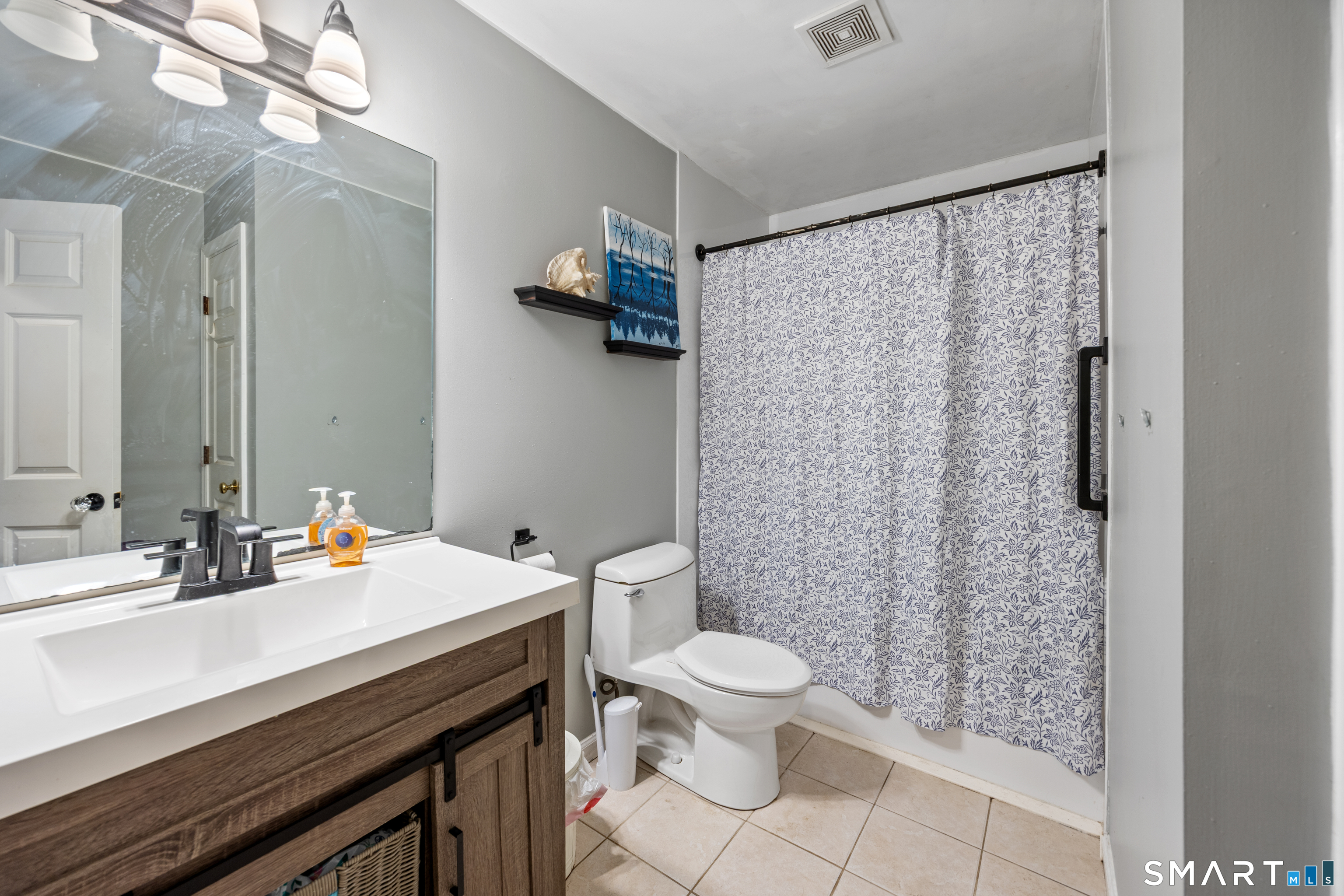 197 Preston Road Plymouth, CT 06786 - Photo 29 of 39 a bathroom with a sink a toilet and shower curtain