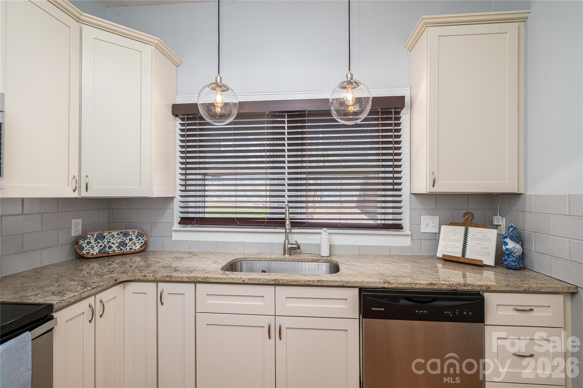 58 Fourth Street Cramerton, NC 28032 - Photo 30 of 44 a kitchen with granite countertop a sink cabinets and window