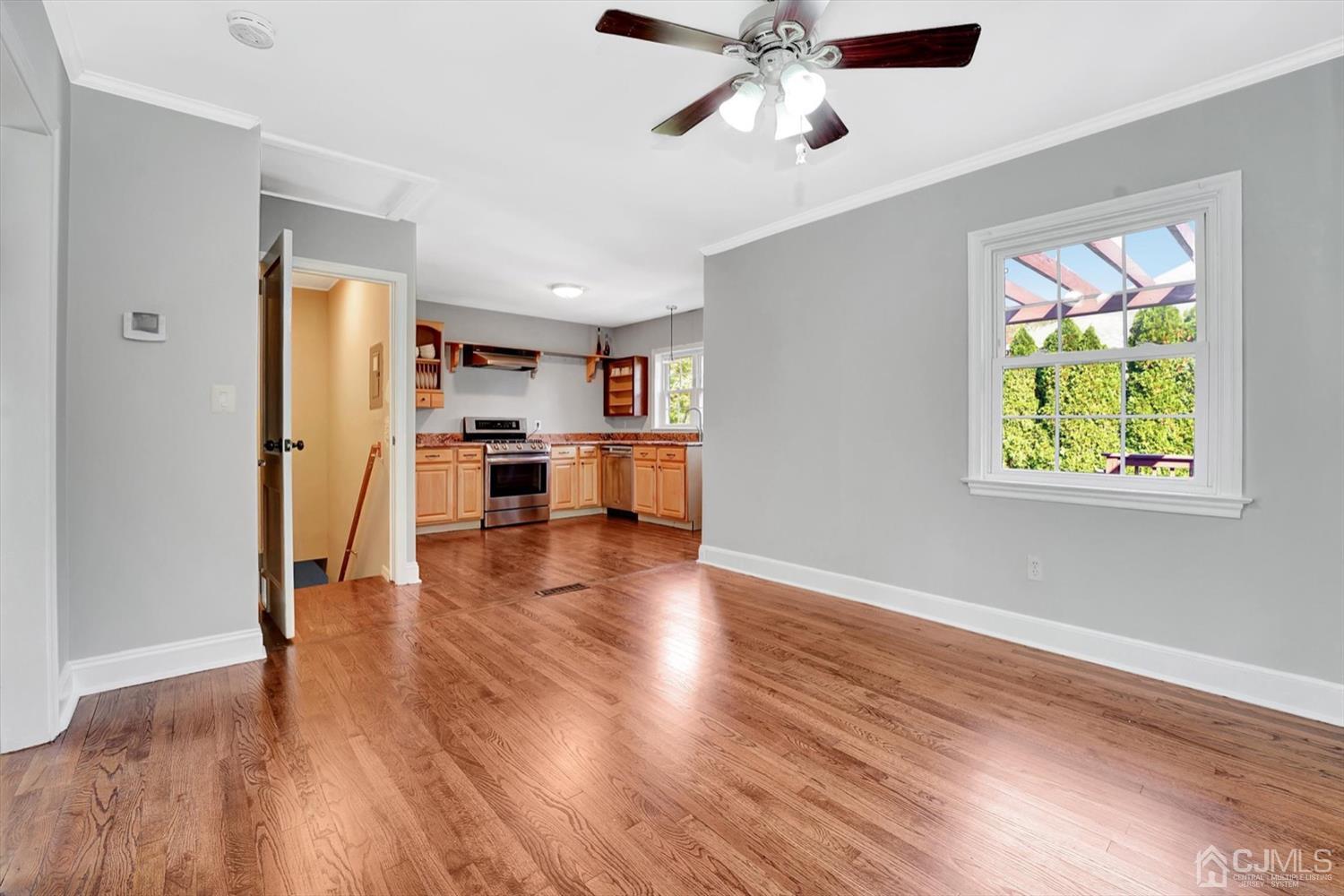 14 Middlesex Road Matawan, NJ 07747 - Photo 11 of 27 a view of a kitchen with a stove wooden floor a ceiling fan and windows