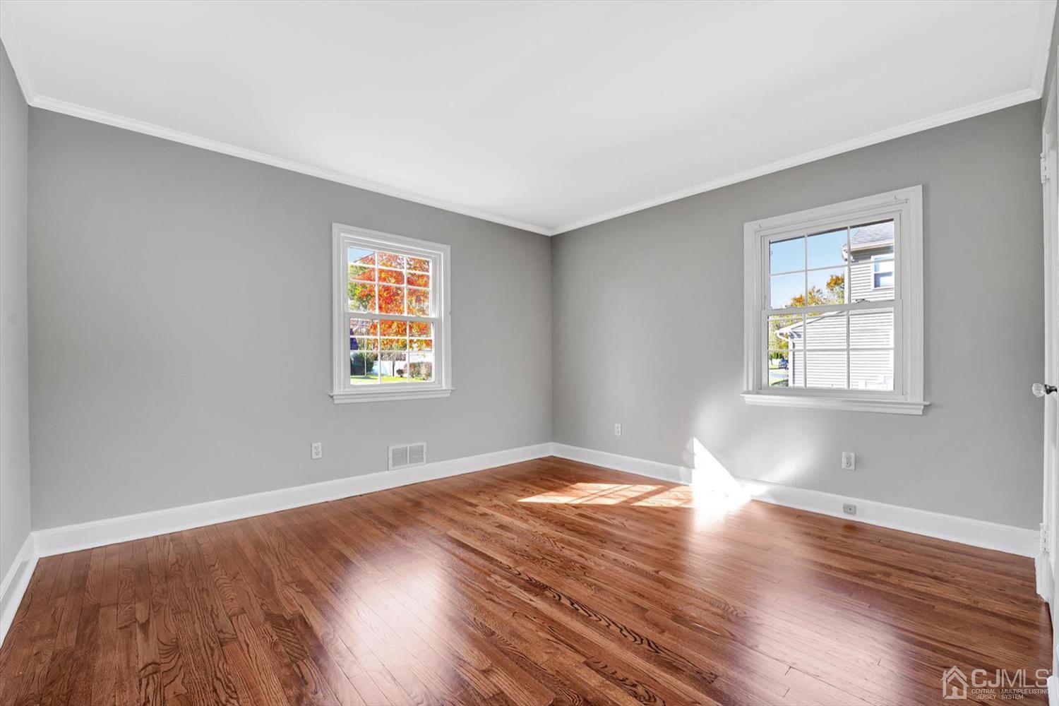 14 Middlesex Road Matawan, NJ 07747 - Photo 16 of 27 a view of an empty room with wooden floor and a window