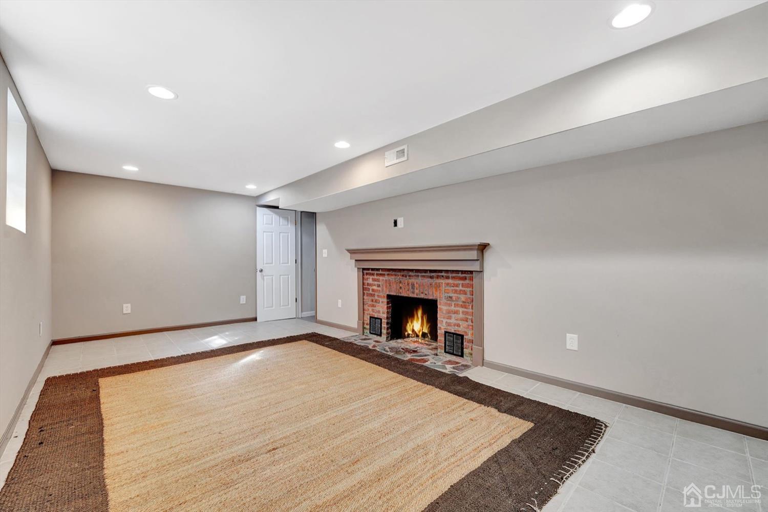 14 Middlesex Road Matawan, NJ 07747 - Photo 17 of 27 a view of an empty room with a fireplace and a window