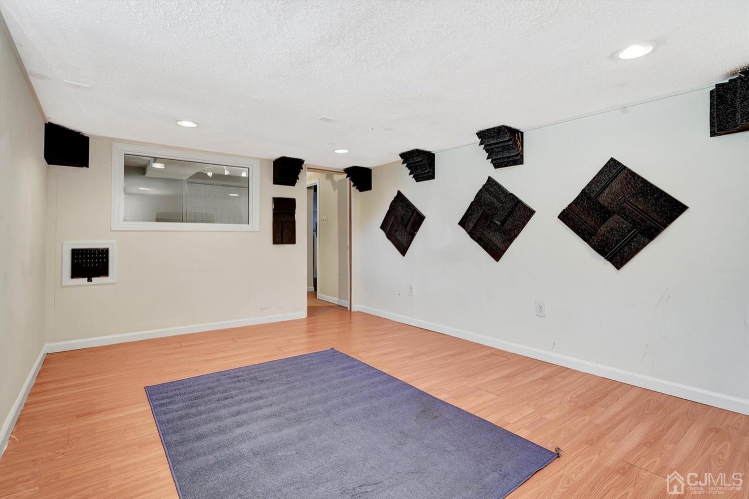 14 Middlesex Road Matawan, NJ 07747 - Photo 19 of 27 an empty room with wooden floor and windows