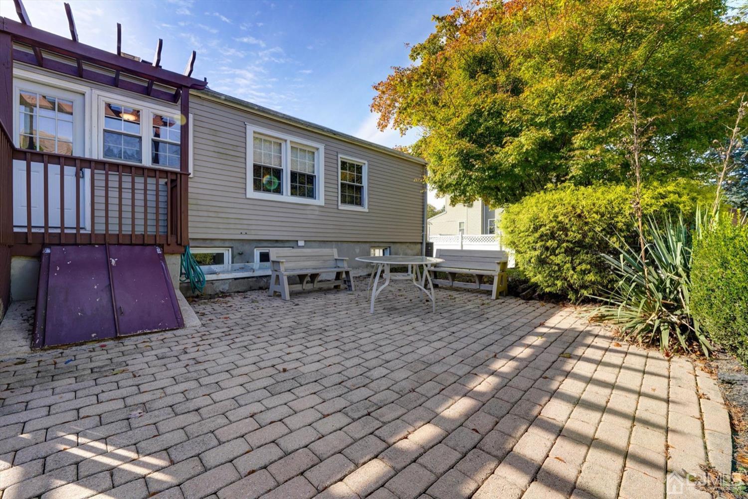 14 Middlesex Road Matawan, NJ 07747 - Photo 22 of 27 a view of a patio with table and chairs and potted plants