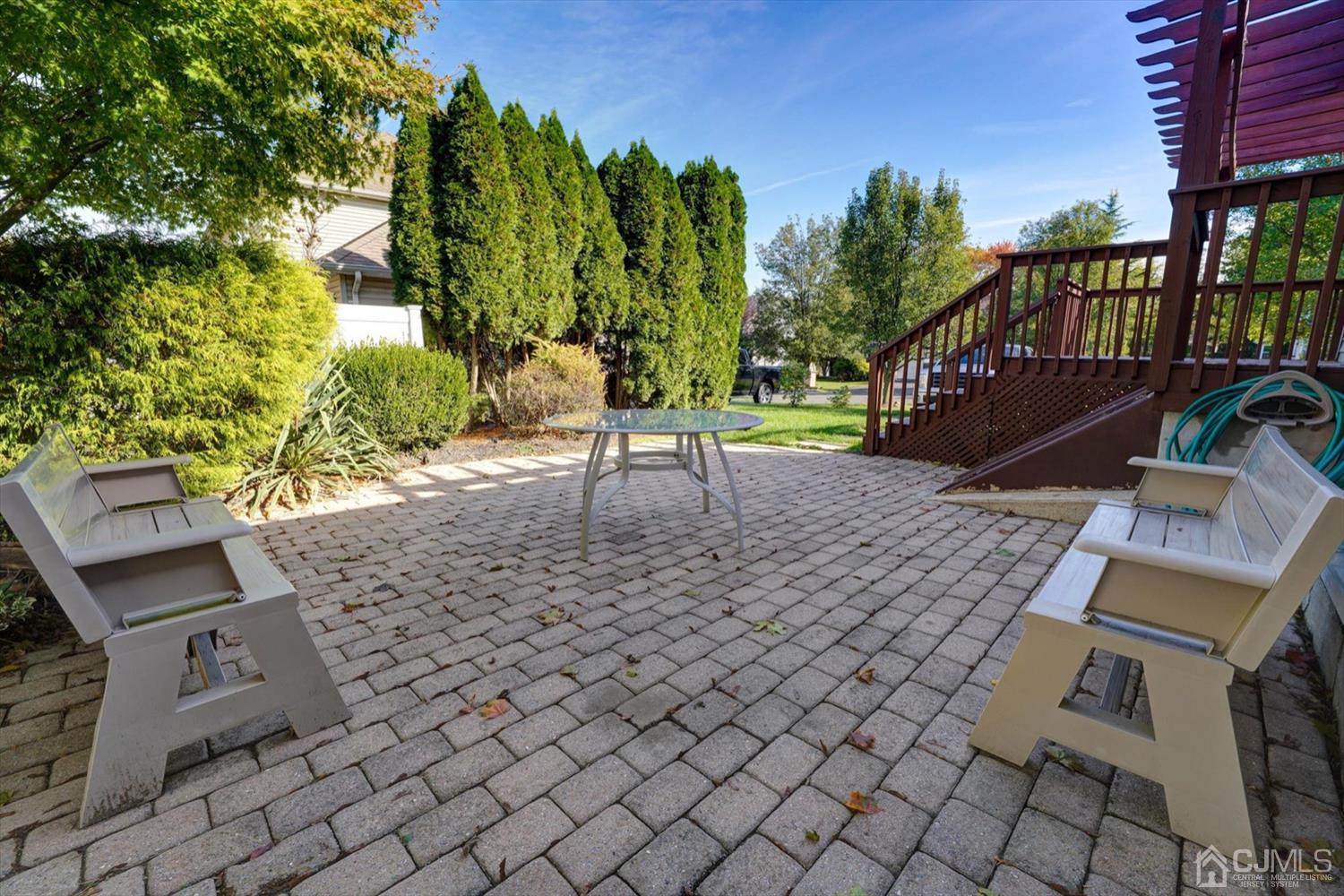 14 Middlesex Road Matawan, NJ 07747 - Photo 23 of 27 a view of a patio with table and chairs with wooden fence and plants
