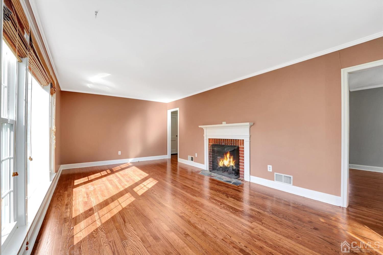 14 Middlesex Road Matawan, NJ 07747 - Photo 5 of 27 a view of an empty room with wooden floor and a window