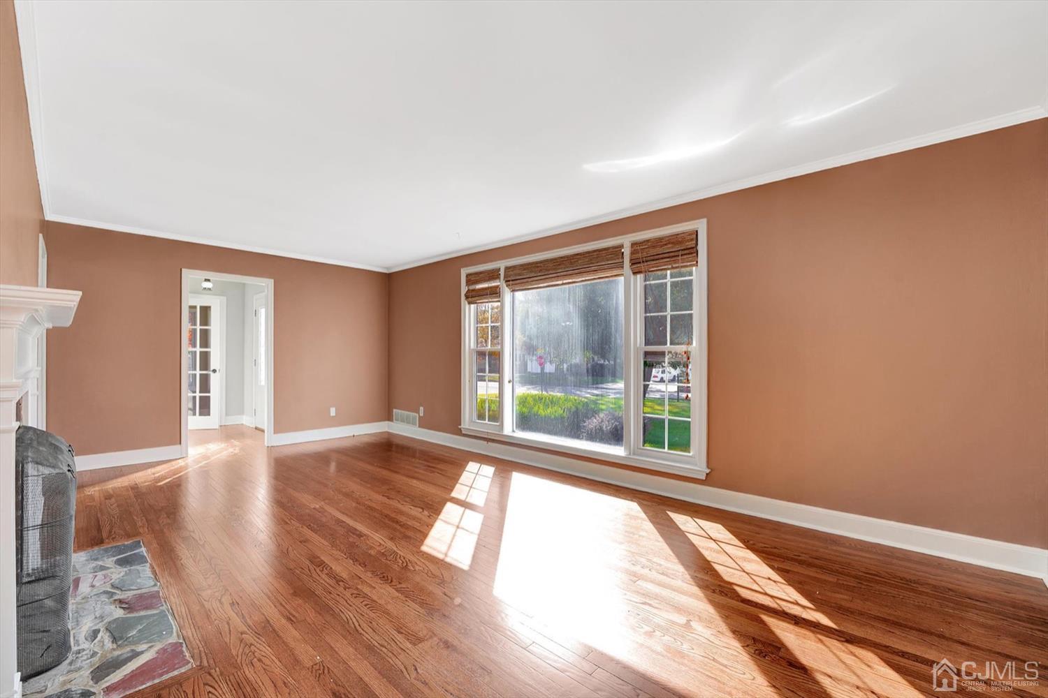 14 Middlesex Road Matawan, NJ 07747 - Photo 6 of 27 a view of an empty room with wooden floor and a window