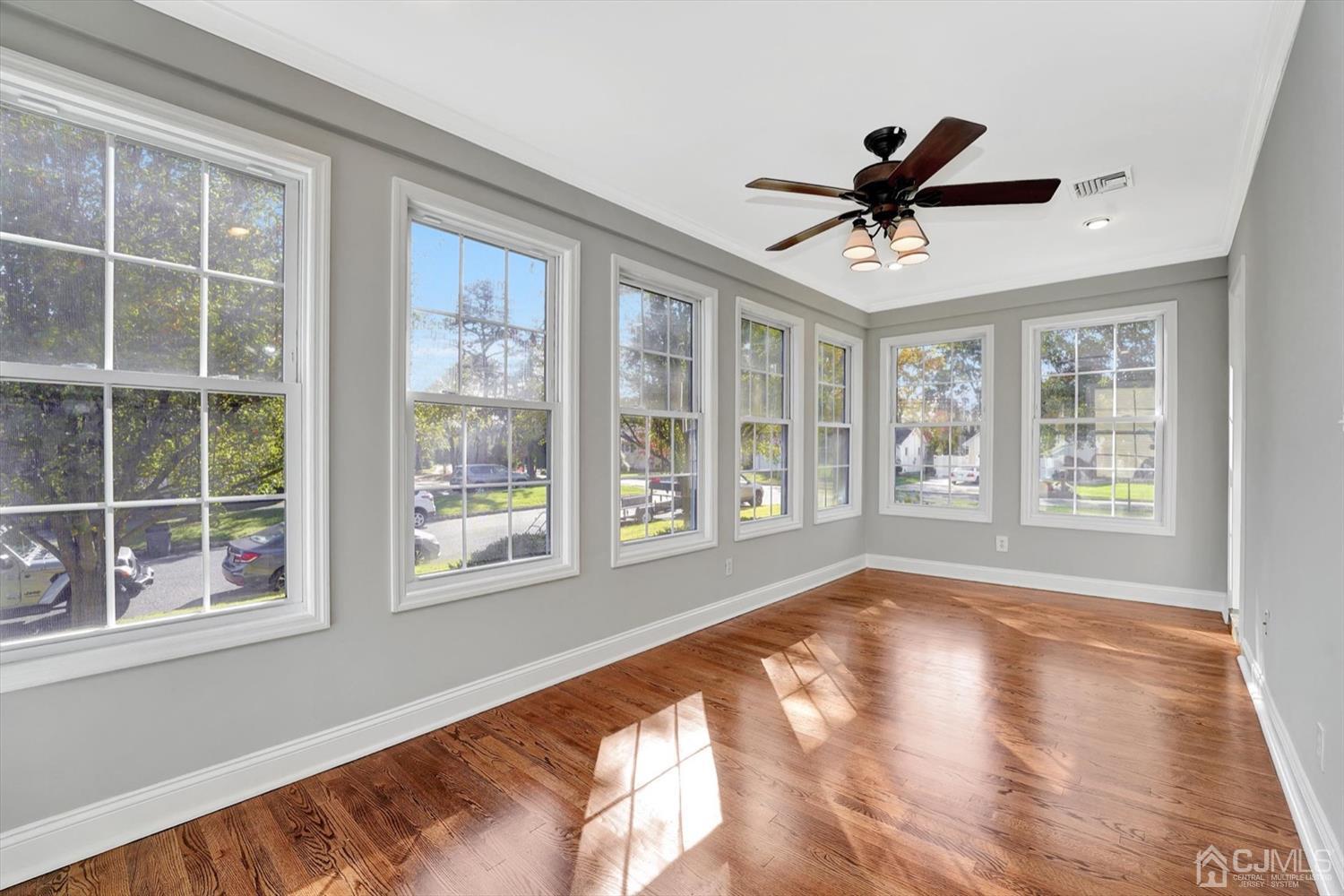 14 Middlesex Road Matawan, NJ 07747 - Photo 9 of 27 a view of an empty room with a window and wooden floor