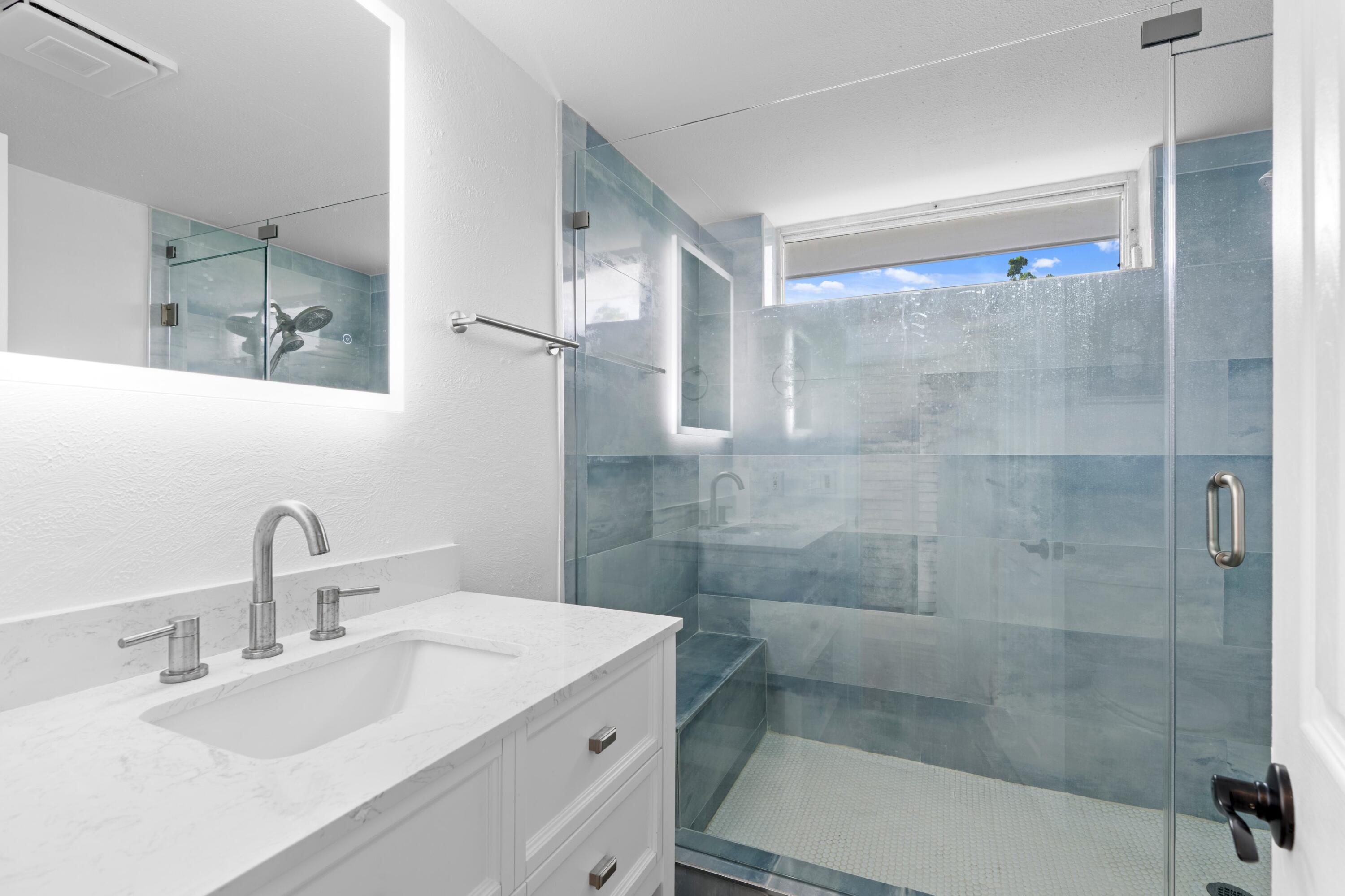 40 Southeast 13th Street, Unit B1 Boca Raton, FL 33432 - Photo 12 of 34 a bathroom with a sink and mirror with shower