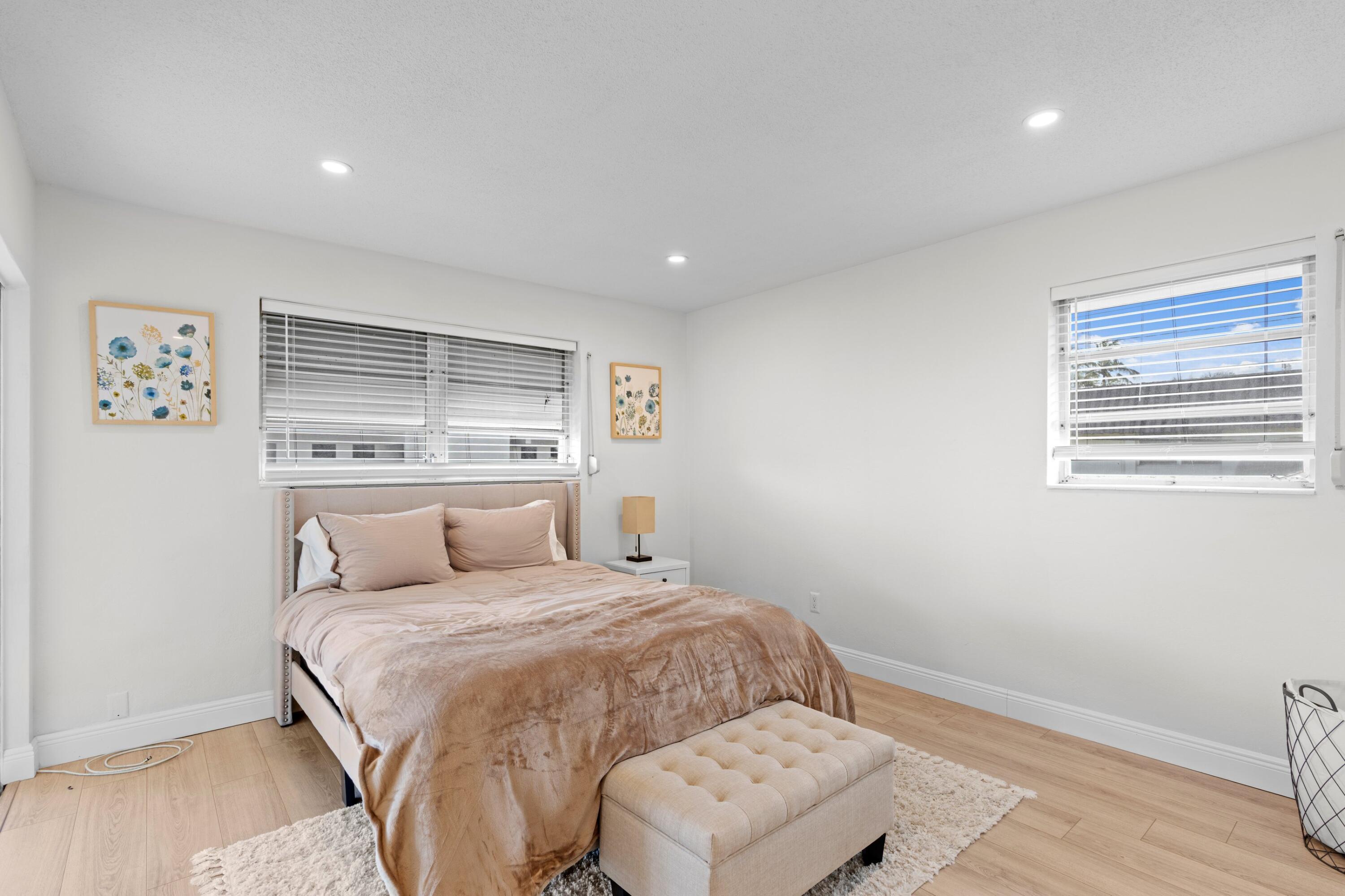 40 Southeast 13th Street, Unit B1 Boca Raton, FL 33432 - Photo 10 of 34 a bedroom with a large bed and a window