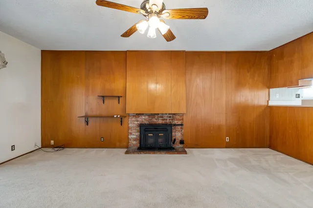 a view of a livingroom with a ceiling fan and window